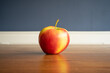 An apple on a wooden table