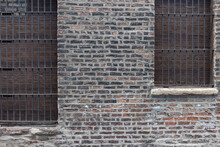 Vintage Brick Wall With Iron Bars Covering The Windows In Alley In Downtown Chicago