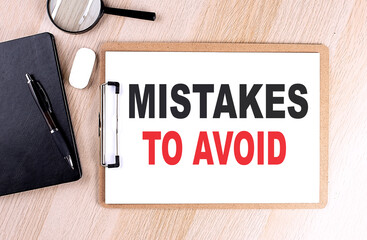 Poster - MISTAKES TO AVOID text on clipboard on wooden background