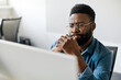 © Prostock-studio - Thoughtful black man in eyeglasses stack with hard task, looking at computer screen, thinking of problem solution