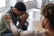 © Prostock-studio - Closeup of african american psychologist helping depressed young man