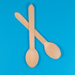two wooden spoons on a blue background