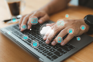 Fototapete - businessman using his laptop in an office and selecting the cloud icon on a virtual display. This represents the utilization of digital technology and cloud technology.
