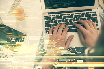 Fototapete - Multi exposure of man's hands typing over computer keyboard and data theme hologram drawing. Top view. Technology concept.