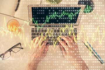 Poster - Double exposure of man's hands typing over laptop keyboard and forex chart hologram drawing. Top view. Financial markets concept.