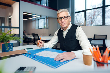 Wall Mural - Mature man working on architectural project in office