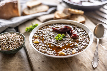 Wall Mural - A plate full of lentil legume soup with baked sausage and fresh bread