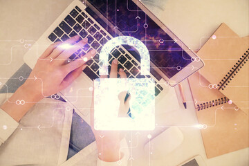 Poster - Double exposure of woman hands working on computer and lock hologram drawing. Top View. Security concept.