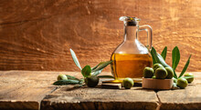 Glass Container With Olive Oil Branches And Olives On A Wooden Background. Long Banner Format