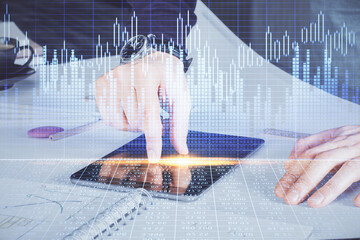 Aufkleber - Double exposure of man's hands holding and using a digital device and forex graph drawing. Financial market concept.