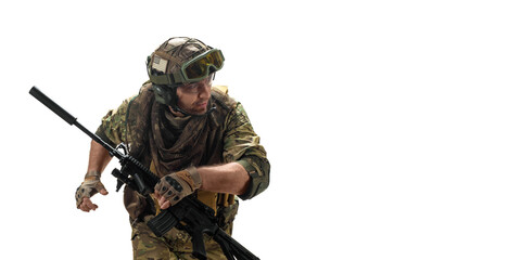 Wall Mural - Army soldier with an automatic rifle looks back while running.