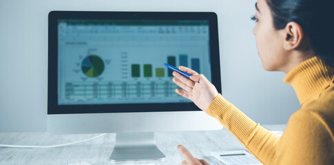 Wall Mural - woman working in computer with graph in office