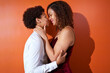 © Caia Image - Portrait happy lesbian couple with curly hair smiling face to face