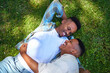© Caia Image - View from above happy, affectionate gay male couple laying in grass