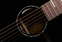 Guitar Sound Hole And Strings Shot From Above In Flat Lay Style. Beautiful Black Acoustic Guitar In Close Up