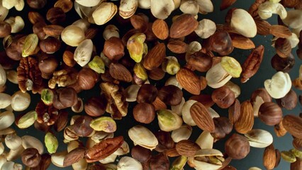 Poster - Super slow motion of rotating mix nuts up to the air. Filmed on high speed cinema camera, 1000fps, placed on high speed cine bot.