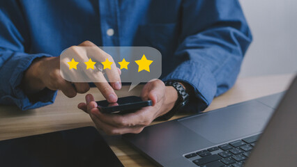 Wall Mural - close up on customer man hand pressing on smartphone screen with gold five star rating feedback icon