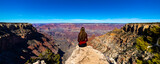 Fototapeta  - long haired hiker girl sitting on the edge of grand canyon; hiking in the grand canyon national park during spring, spring panorama of grand canyon