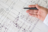 Fototapeta Mapy - Architect, Engineer, drawing up plumbing and drainage blueprints