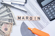 © Kamil - margin inscription next to dollars and calculator. A concept showing the company's margins.