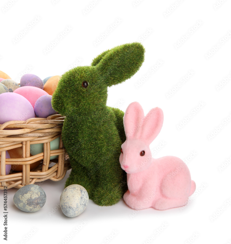 Easter bunnies and wicker basket with painted eggs isolated on white background