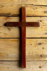 Canvas Print - Image of close up of cross and copy space on wooden background