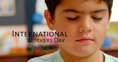 Poster - Animation of caucasian boy and international workers day text