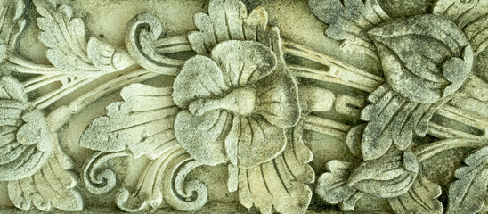 Wall Mural - Carved concrete flower design with mildew and stains