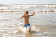 © 3Days2Go Media - Youth Child Preteen Boy Running Into the Waves and Ocean Water at the Sunny Beach