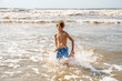 © 3Days2Go Media - Youth Child Preteen Boy Running Into the Waves and Ocean Water at the Sunny Beach