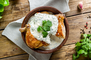 Wall Mural - chicken chkmeruli in Georgian on old wooden table top view