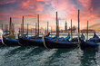 Gondolas moored in grand canal,
with San Giorgio di Maggiore church at sunset in Venice, Italy - Travel concept