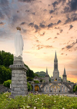 Landscape Of The Sanctuary Of Our Lady In Lourdes At Sunset, France -  Religious Tourism Concept