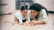 © T Mdlungu/peopleimages.com - Baby, mother and toy building blocks for child knowledge development on living room floor. Family home, teaching and mom with girl toddler learning and helping with happiness and a smile with love