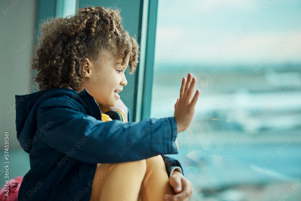 Girl child, wave and airport window for greeting, goodbye and smile for airplane, international transport and travel. Kid, happy and hand gesture by glass for global immigration, young and African