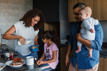 Wall Mural - Hispanic family mother and child daughter preparing breakfast at kitchen in Mexico Latin America