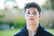 © Charlize D/peopleimages.com - Man, portrait and face at outdoor park in summer for walk, wellness and fitness by blurred background. Young gen z guy, headshot and nature in spring with handsome, confident and focus in sunshine