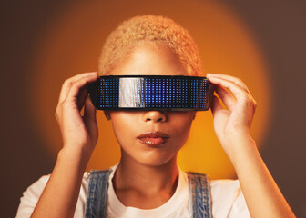 Poster - Black woman, vr and futuristic cyberpunk glasses in online metaverse app or game or video on brown background. Virtual reality, future fashion and digital augmented reality goggles on model in studio