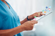 © Coetzee/peopleimages.com - Doctor, hands and tablet in healthcare research, app or software icons for innovation or communication at clinic. Hand of woman medical expert, nurse or specialist on touchscreen for medicare search