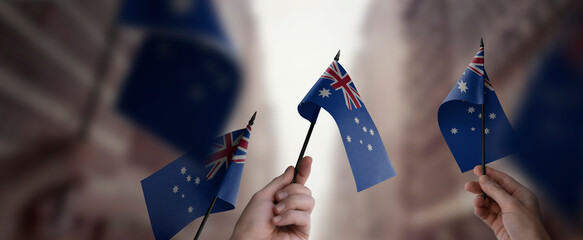 A group of people holding small flags of the Australia in their hands