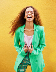 Portrait, fashion and woman laughing on yellow background, color wall and backdrop with smile in Colombia. Happy young female, trendy style and green clothes for beauty, curly hair and gen z model