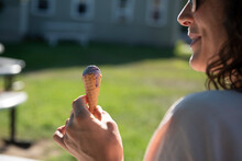 A Woman Eating The Last Part Of An Ice Cream Cone In The Sunshine