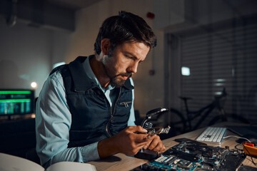 Poster - Man, circuit and it repair workshop in night for maintenance, computer tech or industry with focus. Technician, motherboard and information technology in dark with electronics, engineering and tools