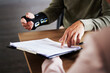 © Courtney H/peopleimages.com - Injury, compensation and man hands with insurance documents, legal contract and paperwork. Disability, accident and people in lawyer or attorney meeting for advice, agreement or policy report closeup