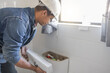 © Lumeez/peopleimages.com - Toilet, plumbing worker and man at cistern of home renovation, builder service and maintenance. Plumber, bathroom tank and handyman technician fixing leak, broken pipeline and sewer upgrade in house