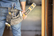 © Lumeez/peopleimages.com - Maintenance man, bag and tools with hands, front door and home improvement service in property industry. Construction worker, back and jeans for working at house, building or real estate development
