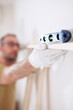 © astrosystem - Man assembling new wooden shelf and furniture in the apartment.