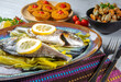 Fish known as bream, cooked in the oven with slices of lemon.