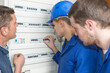 young apprentice electricians learning about fusebox