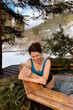 © cenchild - woman with glass of white wine in outdoor hot tub in the mountains for spa and relaxation in nature, therapeutic effects of hydrotherapy